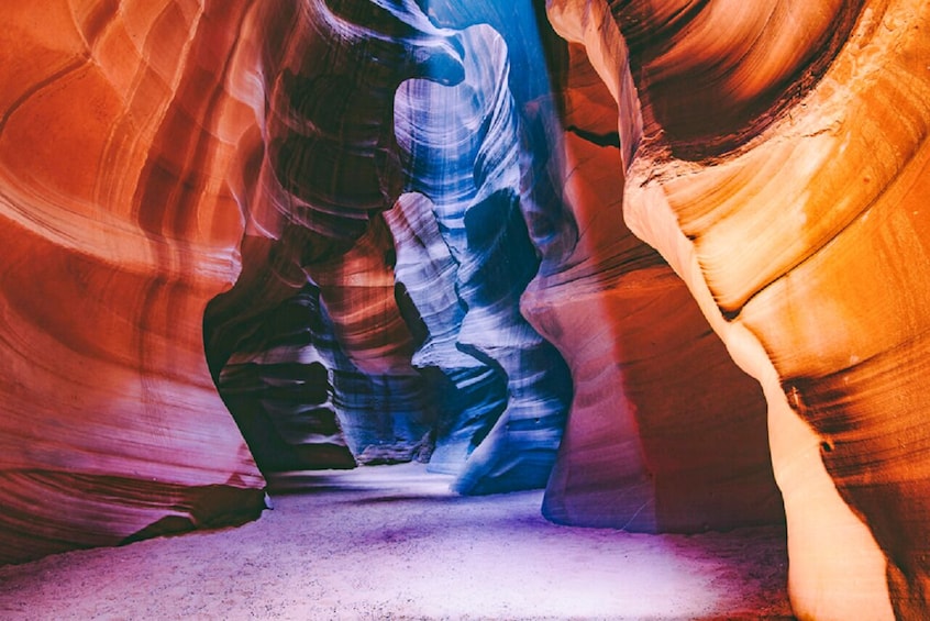 A narrow canyon with smooth, colorful rock walls. 2