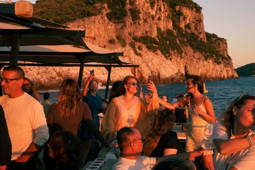 People on a boat near rocky cliffs by the sea. 4