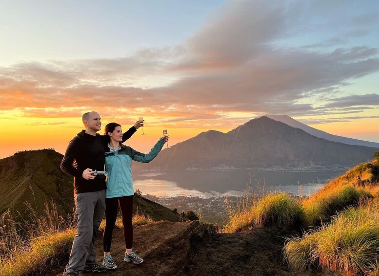 Two people taking a selfie with a mountain and a lake in the background. 1