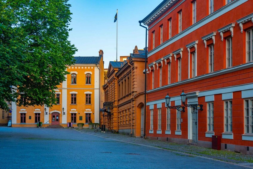 A street with historic buildings, a flag, and a clear sky. 3