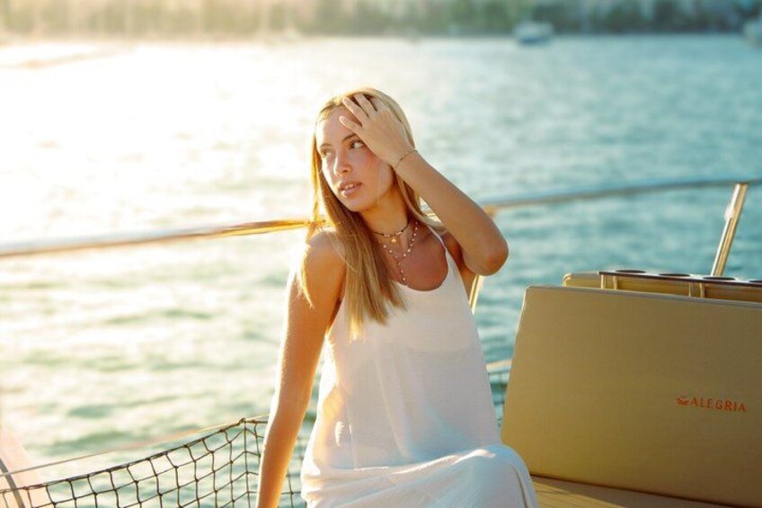 A person on a boat with a laptop, water, and a net. 2