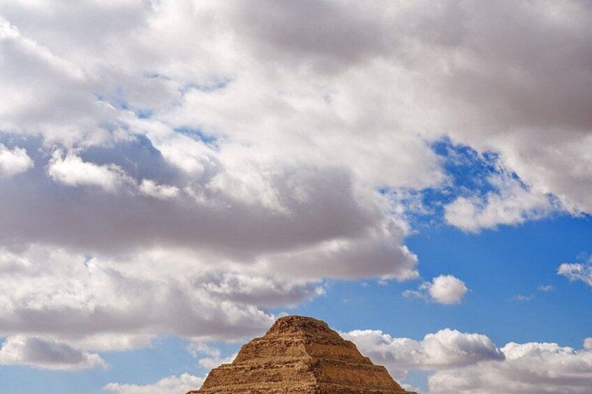 A pyramid under a cloudy sky. 5
