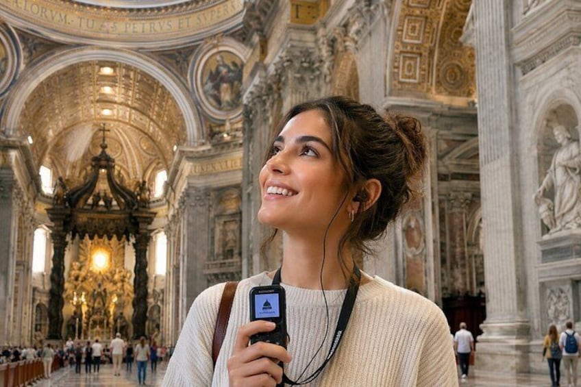 A person inside a grand, ornately decorated building with high ceilings and detailed sculptures. 1