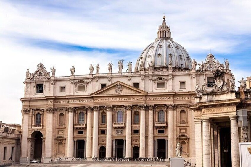 A grand historical building with a large dome and statues. 4