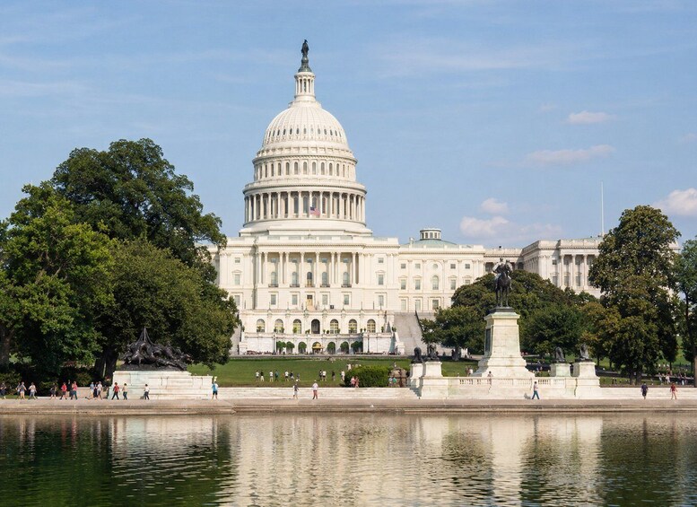 The United States Capitol building with a reflecting pool in front. 1