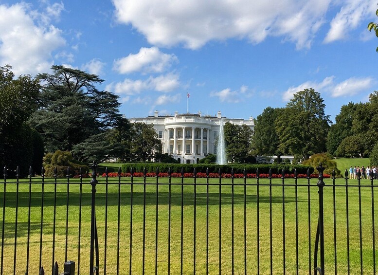 The White House with a fountain in front, surrounded by trees and a well-maintained lawn. 5