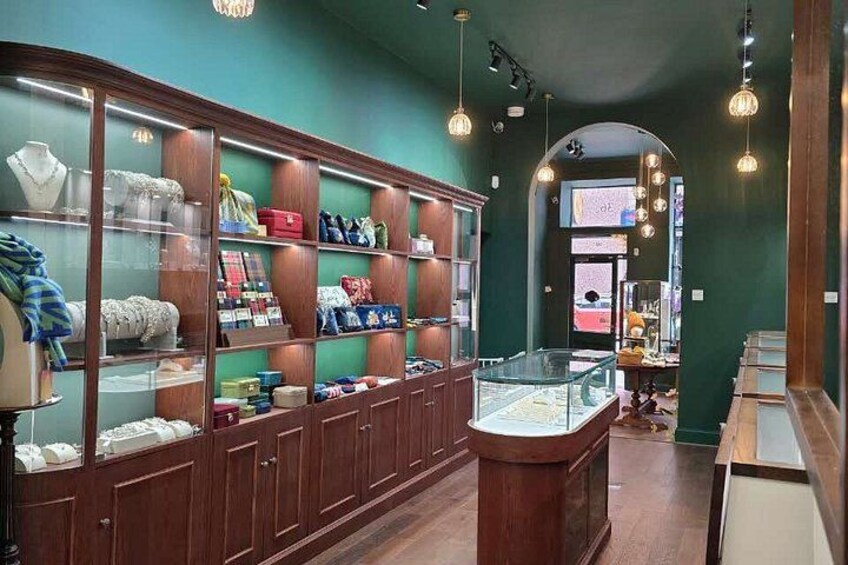 A jewelry store with glass display cases and wooden shelves. 3