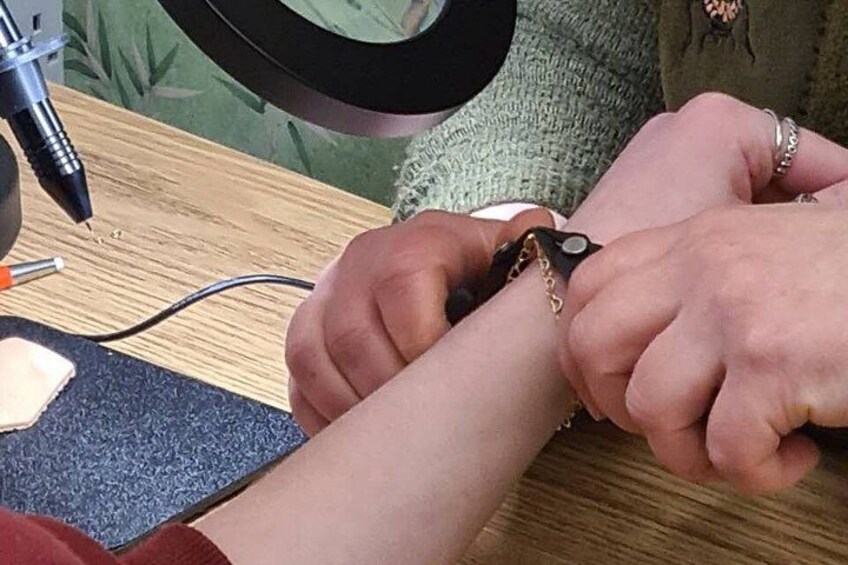 A person getting a tattoo on their arm. 1