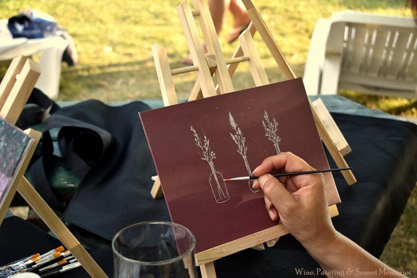 A person painting a still life of two vases with flowers on a canvas. 4