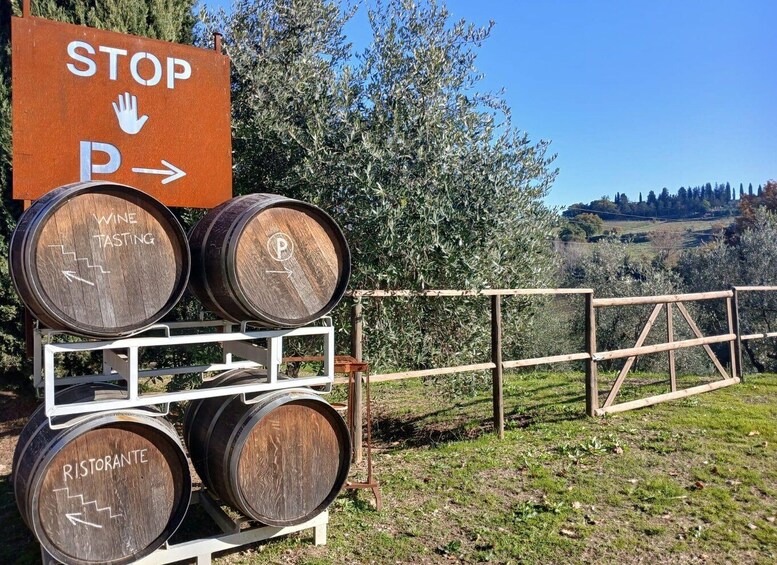 A wine tasting area with barrels labeled 'WINE TASTING' and 'RISTORANTE' and a sign indicating a parking area. 4