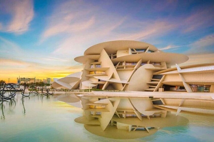 A modern architectural building with a unique design, situated by a calm body of water. 5