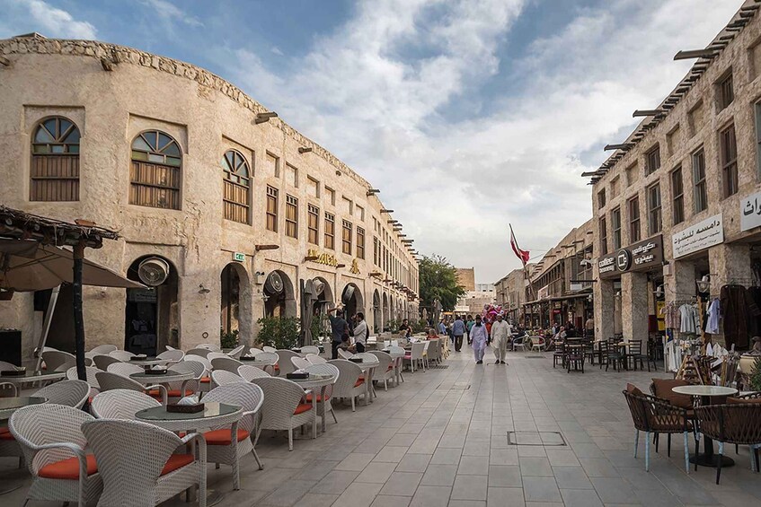 A street with outdoor seating, historic buildings, and a flag. 3