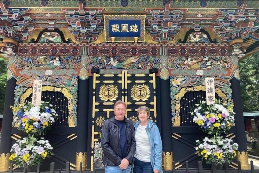 A traditional gate with intricate designs and floral decorations. 3