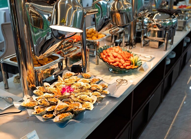 A buffet with various food items, including oysters, vegetables, and other dishes. 5