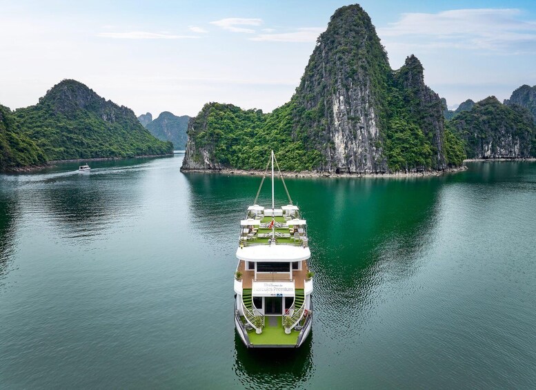 A boat on a calm river surrounded by lush green hills. 4