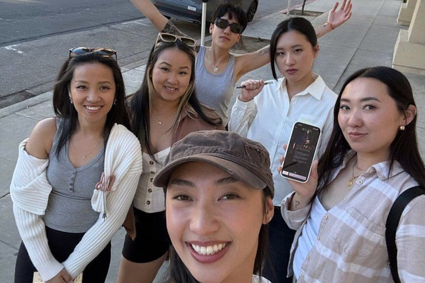 A group of people standing on a sidewalk. 1