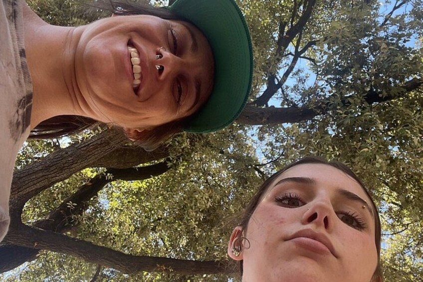 Two people standing under a tree. 4