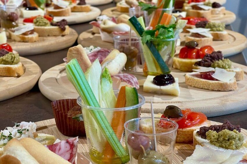 A variety of appetizers and drinks on wooden boards. 2