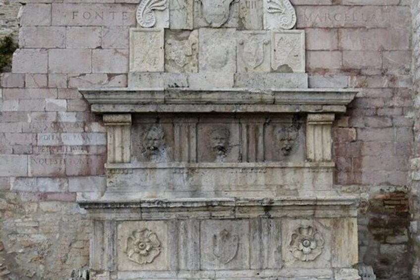 A stone monument with carved figures and inscriptions. 2