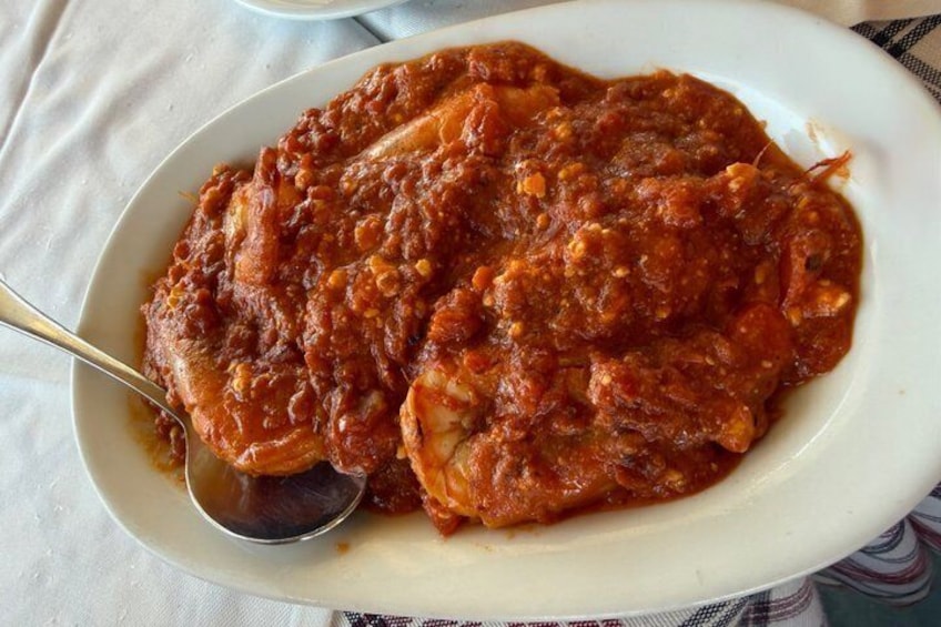 A plate of food with a spoon. 4