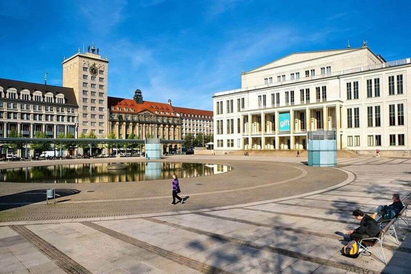 A public square with a fountain, a clock tower, and a building with a 'gith' sign. 4