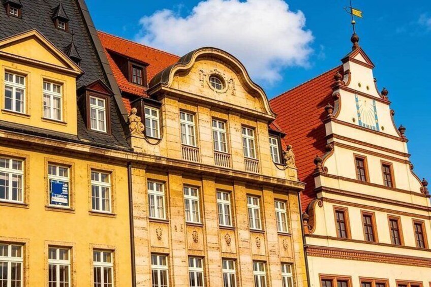 A row of historic buildings with varied architectural styles, including a building with a clock tower. 4