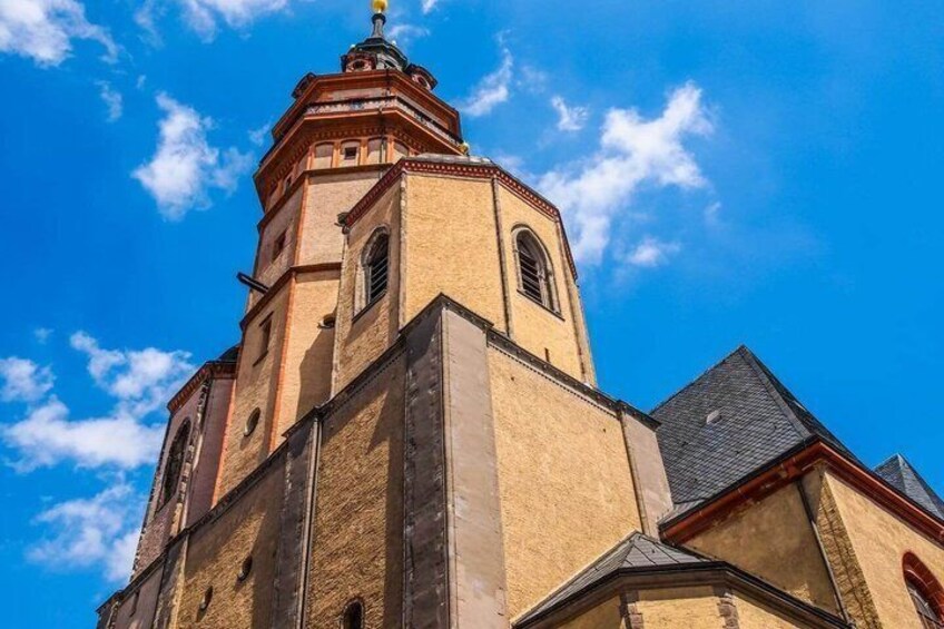 A church with a prominent bell tower and arched windows. 3