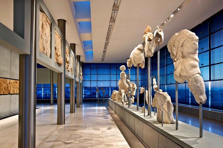 A museum interior with classical sculptures on display. 4