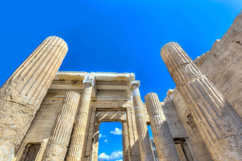 Ancient Greek columns with a clear blue sky in the background. 5