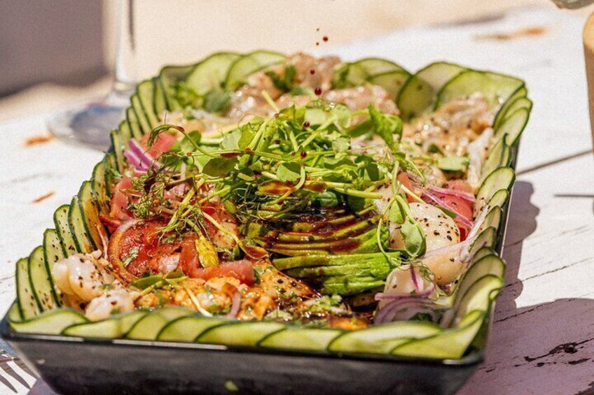 A plated salad with various vegetables and greens. 2