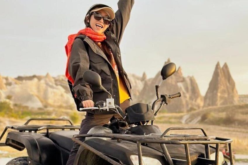 A person on an ATV in a rocky outdoor setting. 2