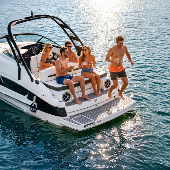 A group of people on a white motorboat with a wake behind it, indicating movement through water. 3