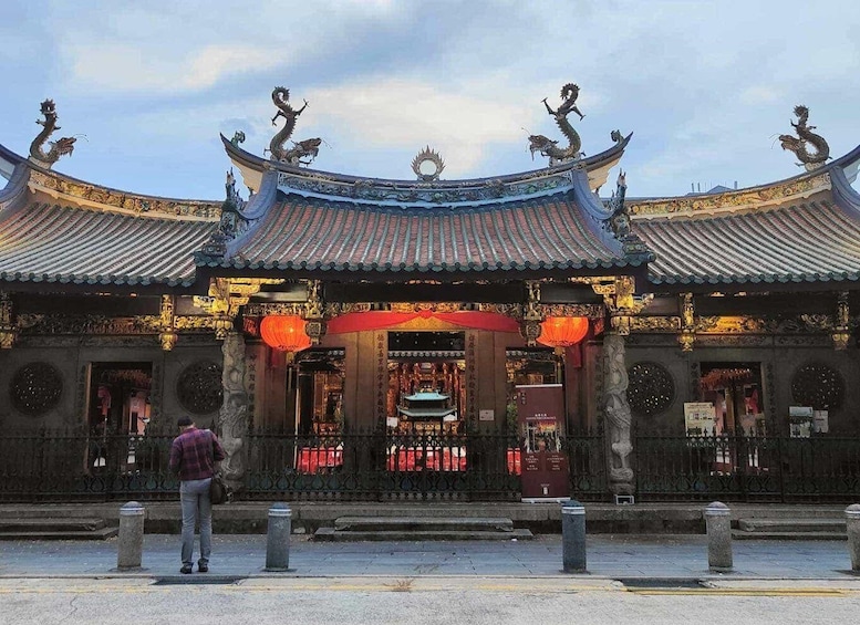 A traditional Chinese temple with ornate roofs and dragon sculptures. 5