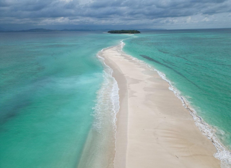 A beach with clear turquoise waters and a sandy shore. 1