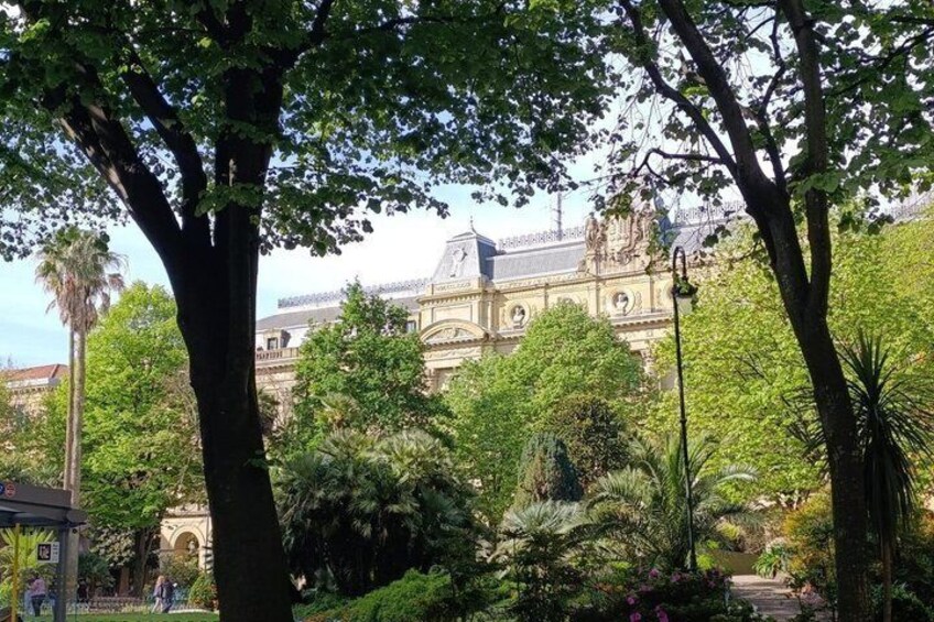 A historic building with ornate architecture, surrounded by lush greenery and trees. 2