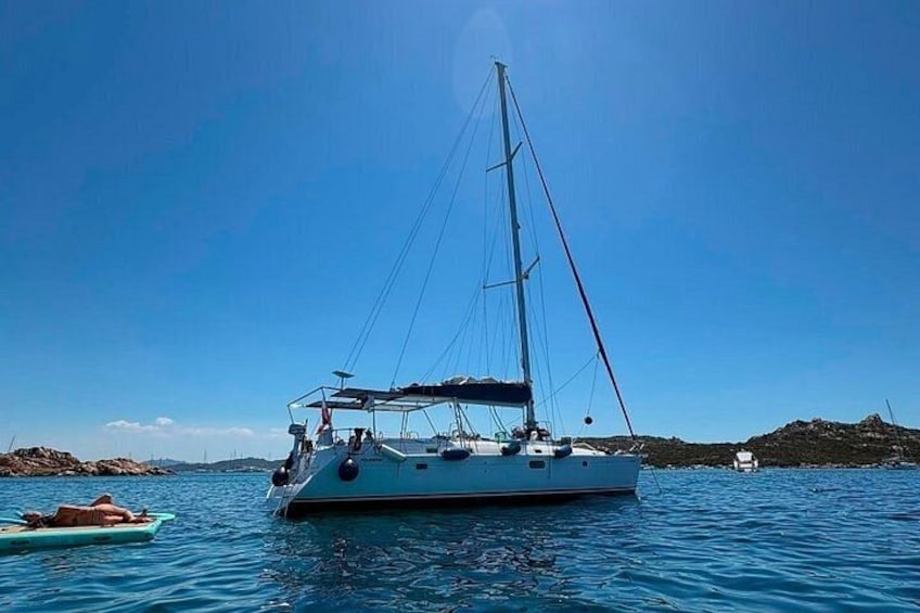 A sailboat on calm waters with a clear sky. 1