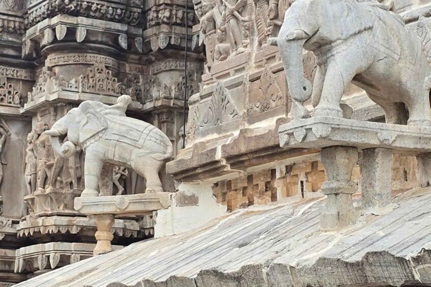 Intricate stone carvings of elephants on a temple roof. 2