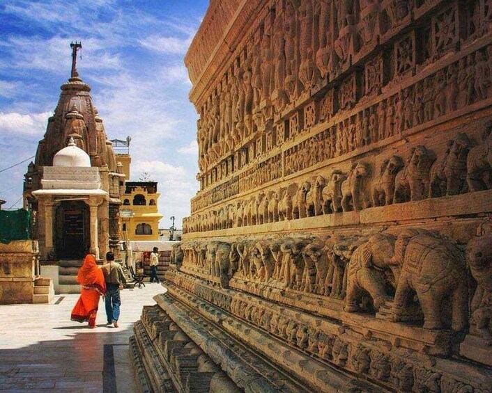 A temple with intricate carvings and a large statue of a deity. 3