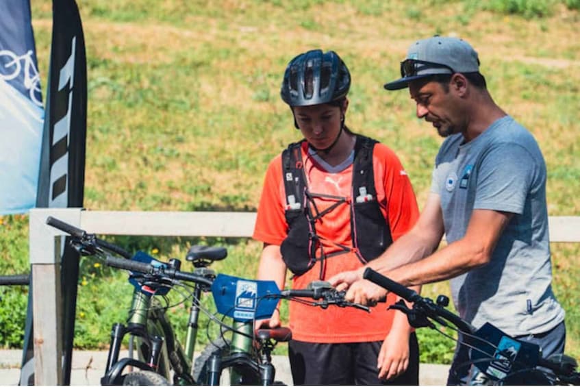 Two people inspecting bicycles. 5