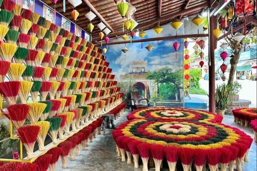 A traditional market with colorful decorations and a central circular floral arrangement. 1