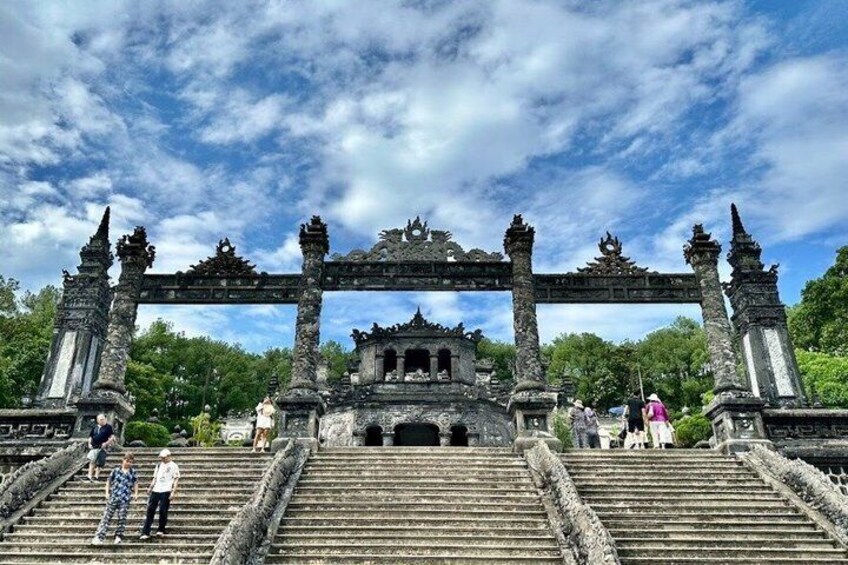 A stone gateway with intricate carvings, leading to a temple complex. 3