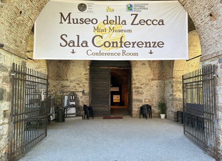 The entrance to Museo della Zecca with a banner reading 'Sala Conference Room.' 2