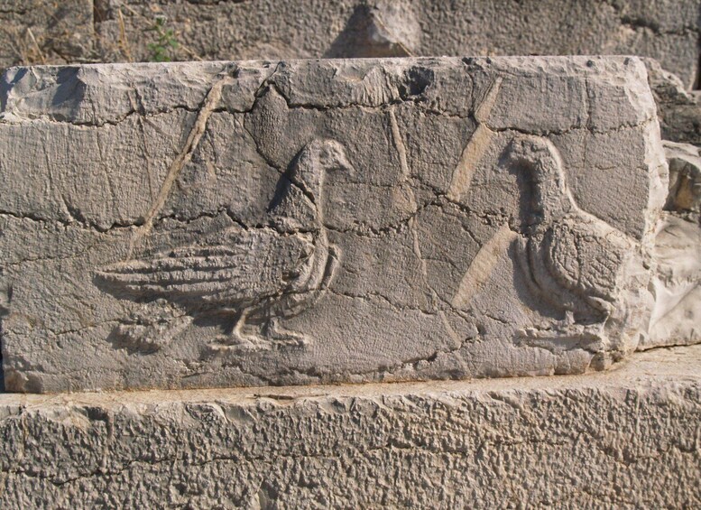 A stone carving of a bird. 1