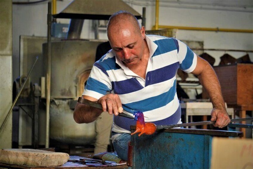 A person working with a tool on a metal object in an industrial setting. 5