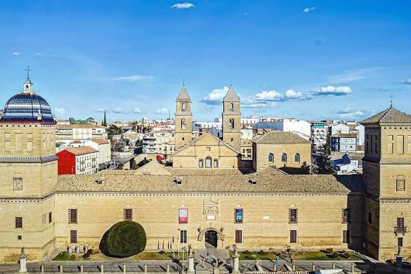 A historic building with a dome and bell tower, surrounded by other structures. 1