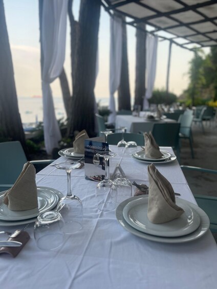 A table set for a meal with a view of the sea. 3