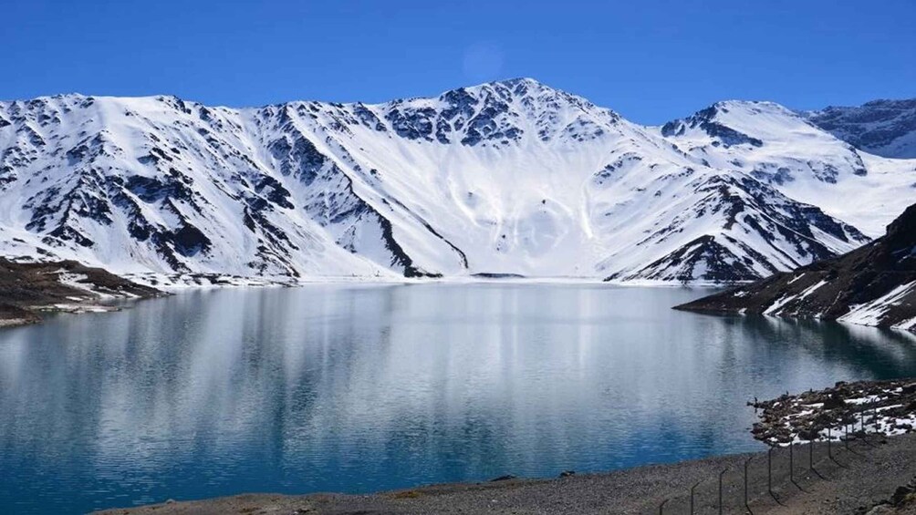 A glacier lake surrounded by snow-covered mountains. 1