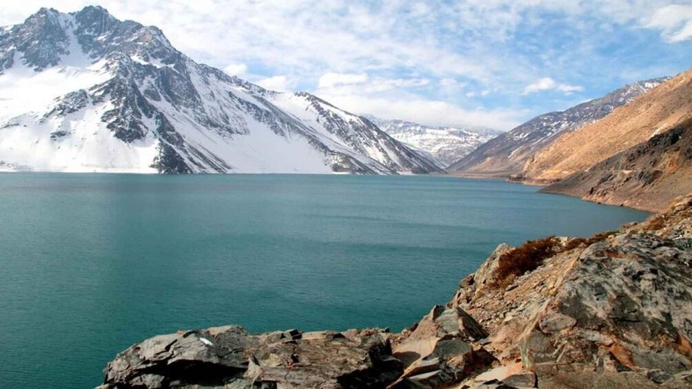A mountain lake with snow-capped peaks and rocky shores. 4