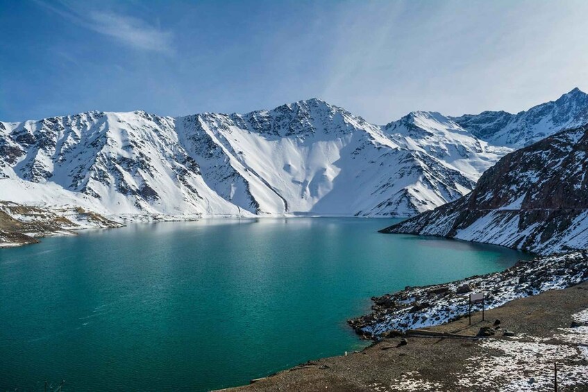 A glacier lake surrounded by snow-covered mountains. 5