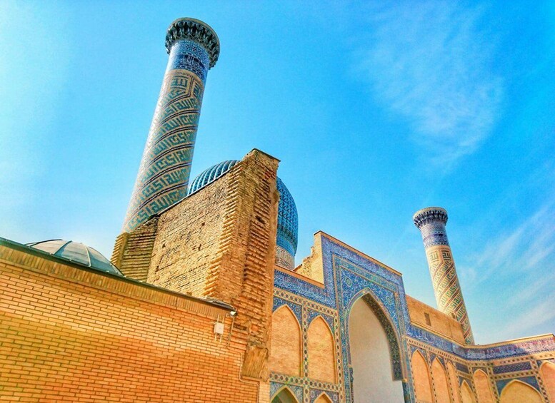 A mosque with tall minarets and intricate blue tile work. 4